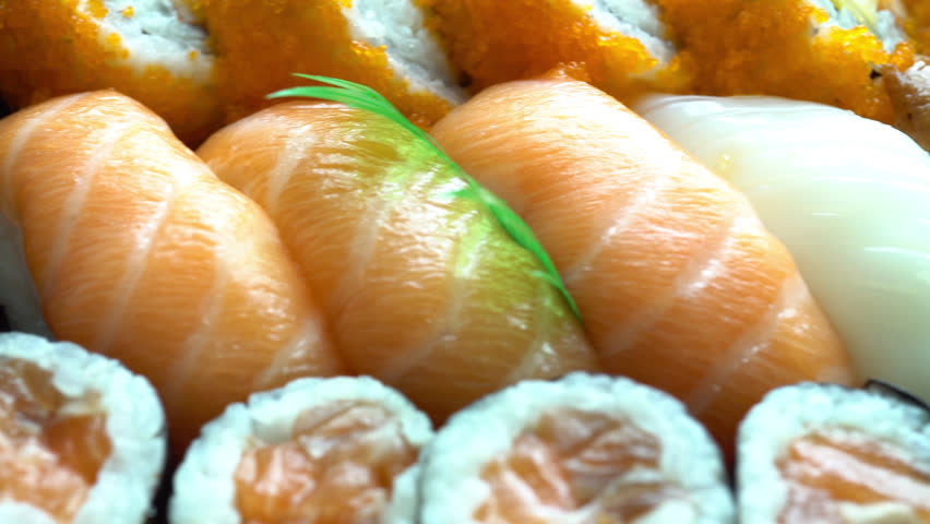 Sliding close up shot of beautifully presented fresh seafood, rice and sushi