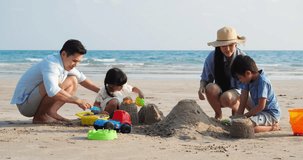 Asian family happy playing build pile of sand on the beach summer together in holiday. Concept of family, travel. 4k resolution.