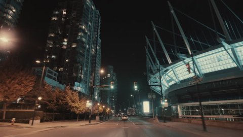 Wide smooth shot of a Vancouver downtown Night road near stadium, Canada