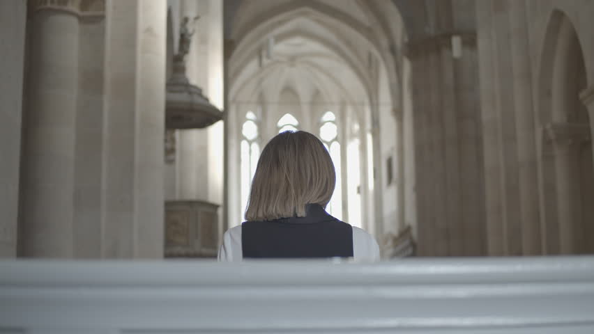 Girl Sitting on a Bench in the Church
