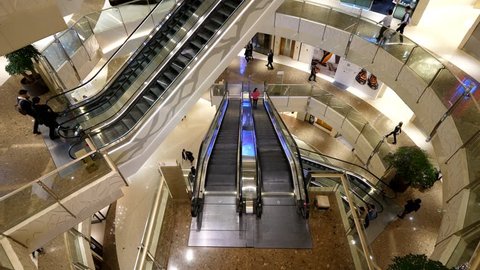 SHANGHAI - MARCH 21, 2018: Top view of atrium at shopping mall, escalators between floors, rather empty area, only few people seen from above. Emporium at IFC Lujiazui, Shanghai