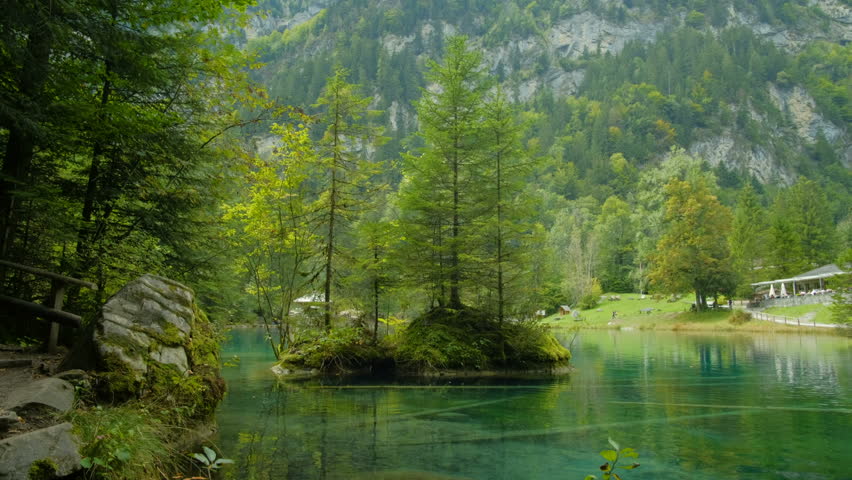 The beautiful blue crystal clear water of the Blausee lake in Kandergrund, Switzerland.