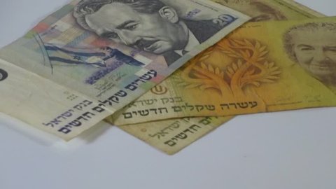 Old money of Israel - 20 twenty shekels bill, 10 (ten) shekels banknote in motion