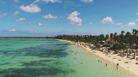 Aerial video of Caribbean tropical beach resort with palm trees and white sand. Travel and vacation in Bavaro. Punta Cana, Dominican Republic.