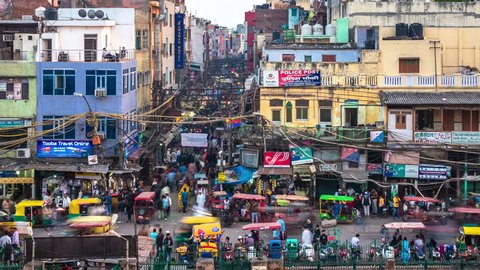Delhi, India - February 18, 2019: Zoom out time lapse view of traffic and people at Chandni Chowk, a busy shopping area and food market in the heart of Old Delhi, India.
