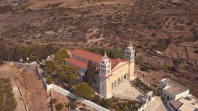 Aerial Drone Shot Starting on the Side of a Church and Slowly Coming Around to Reveal the Front of a Beautiful Church on the Island of Lefkes Village Greece