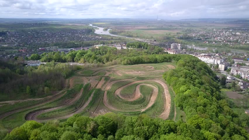 Dirt road tracks in field for motorcycle racing.