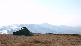 Green tent on amazing meadow in spring mountains. Ultra HD 4K video