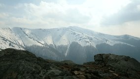 Hiker with backpack in snowy mountains. Ultra HD 4K video