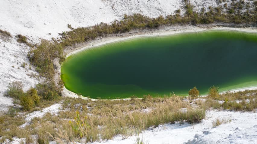 Green Lake is an amazing stock video that exhibits footage of a vibrant lake surrounded by a snowy landscape. This 1920x1080 (HD) footage will look stunning in any video project that relates to bodies