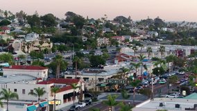 Aerial drone video over downtown Encinitas, California and the Encinitas sign at sunset.
