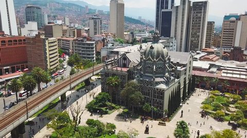 Incredible aerial shot of metro train and Botero Plaza in Medellin city center