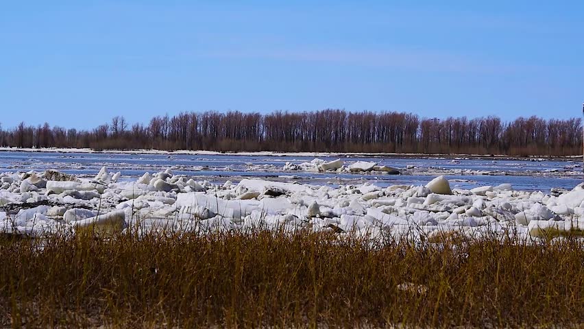 Ice drift, ice movement on the river in early spring on a clear Sunny day, spring landscape