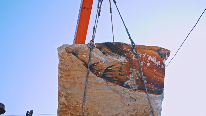 Marble blocks and crane on quarry. Crane machine and equipment for construction site