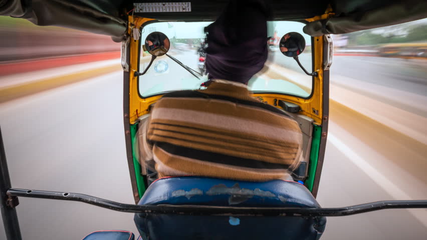 Motion time lapse view of tuk-tuk ride around Delhi, India, travel and transportation concept, Indian culture.