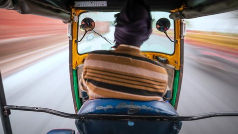 Motion time lapse view of tuk-tuk ride around Delhi, India, travel and transportation concept, Indian culture.