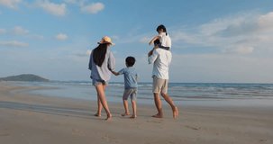 Asian family happy walking relax and resting on the beach summer together in holiday. Concept of family, travel, summer and vacation. 4k resolution.