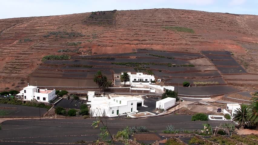 Hillside on Lanzarote with white houses on the foot of the mountain, Spain.