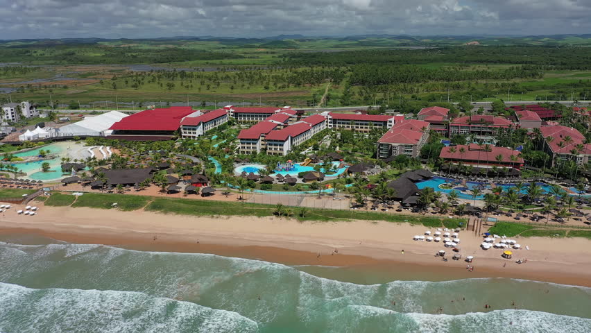 Aerial view of tourist resort town Porto de Galinhas, white sand beach and turquoise bright-water of Atlantic Ocean - landscape panorama of Brazil from above, South America