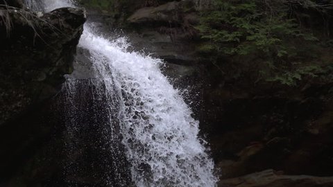 Tracking shot of waterfall water falling slow motion