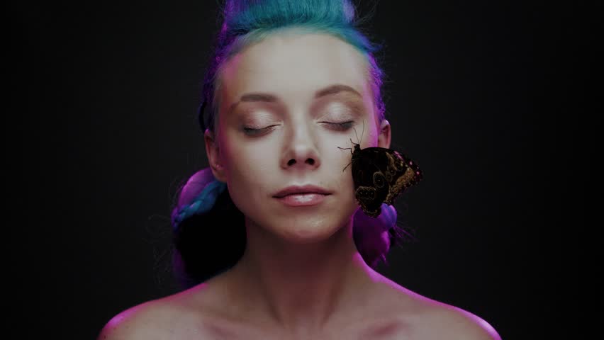 Beautiful woman with blue hair and butterfly