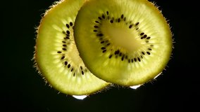 Fresh kiwi fruit sliced with water droplet clips.closeup kiwi sliced with detail and water drop.freshness concept