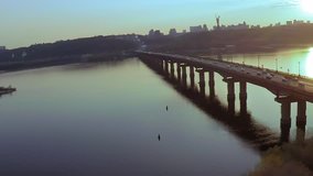 Aerial view of the Bridge across the wide Dnieper river in Kiev before sunset in spring