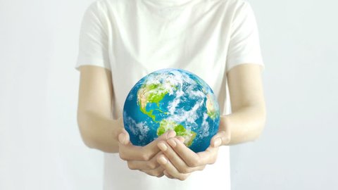 Woman holding the Planet in hands. Young adult hands holding the globe on white background. Conservation concept.
