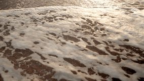 Slow motion amazing video of sea waves on the beach at sunset