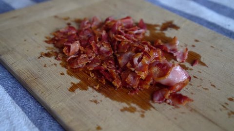 Close Up of a Man Chef chopping crispy bacon for breakfast. Food Preparation.