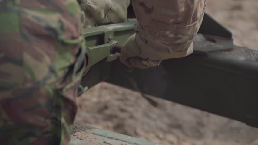 Soldiers are preparing a tank before firing