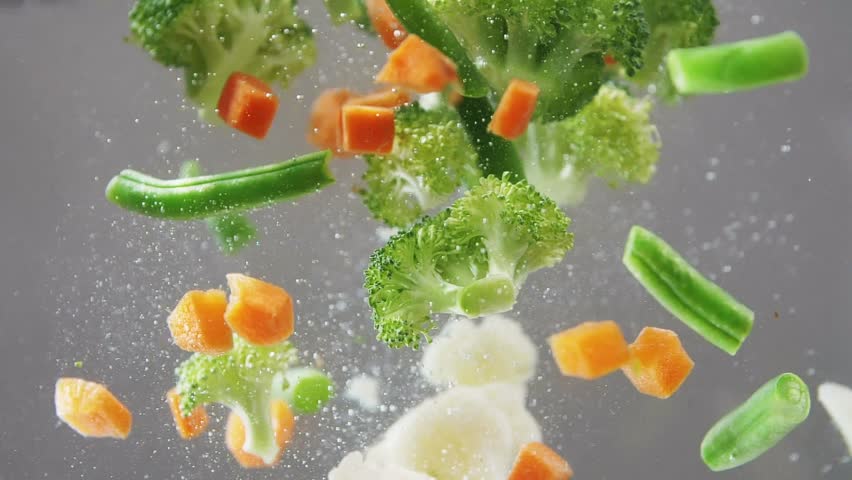 Fresh vegetables falling under water on white background in slow motion. Salad, healthy food, delicious. Diet, vegetarian lifestyle, eco products, organic. Vitamins. Close up view | Shutterstock HD Video #1028829959