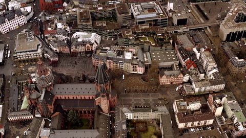 The cathedral in central Mainz, Germany. Drone flight over the church looking down from heaven. The market place can be seen in the back with many people.