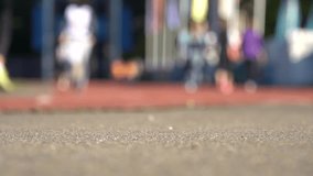 Blurred background of runners on stadium. Amateur sport footage slowmotion