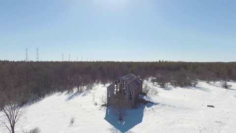 Old winter barn in Canadian forest.