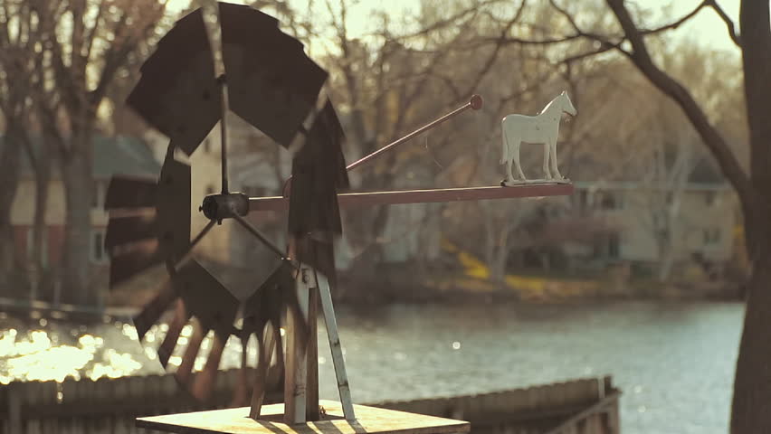 Backyard farm-like weather vane spinning in the wind