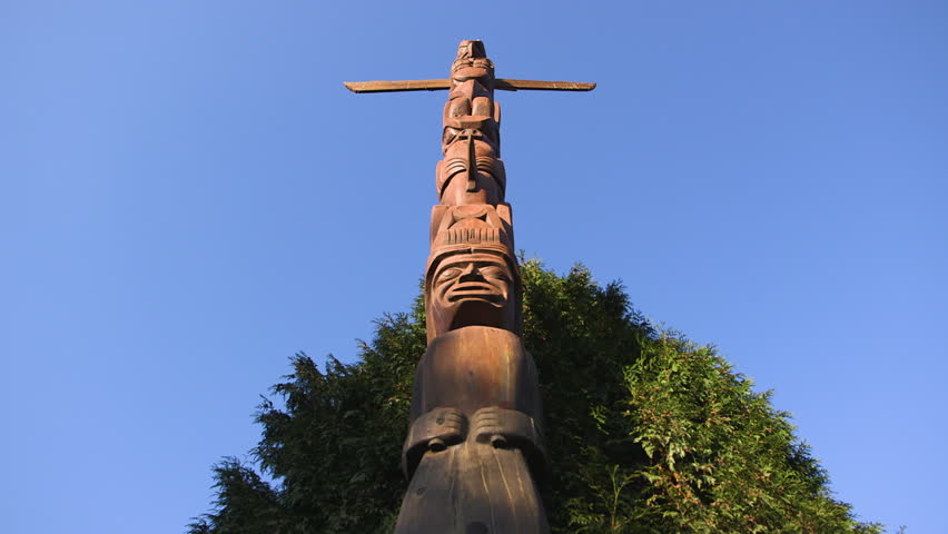 Tall wooden totem pole in downtown Vancouver.