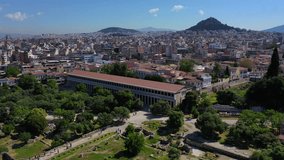 Aerial video of iconic Ancient Forum a true masterpiece in the heart of ancient Athens featuring iconic Stoa of Atalos in the slopes of Acropolis hill, Attica, Greece