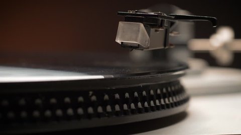 Dropping Stylus Needle On Vinyl Record Playing With Disc Rotating Close Up. Old dusty turntable. Video stock