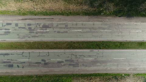 Flying over the old road with cars. Aerial survey
