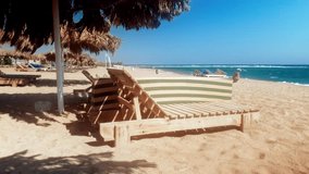 4k video of wooden lounges on abandoned sea beach at windy day