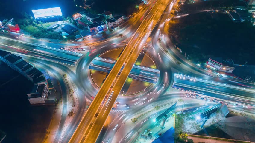 Aerial hyperlapse drone shot of fast moving freeway traffic at night showing cars and light streaks. | Shutterstock HD Video #1028867297