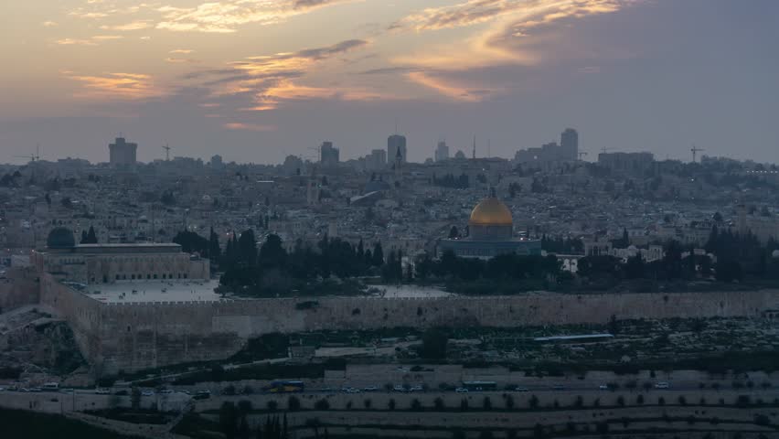 Beautiful panoramic aerial time lapse of the Old City and Dome of the Rock during a dramatic colorful sunset. Taken in Jerusalem, Capital of Israel.