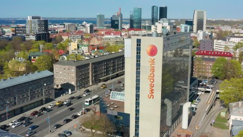 Tallinn / ESTONIA - 29 APRIL, 2019: Aerial pan of Swedbank building in Tallinn, Estonia with rush hour traffic
