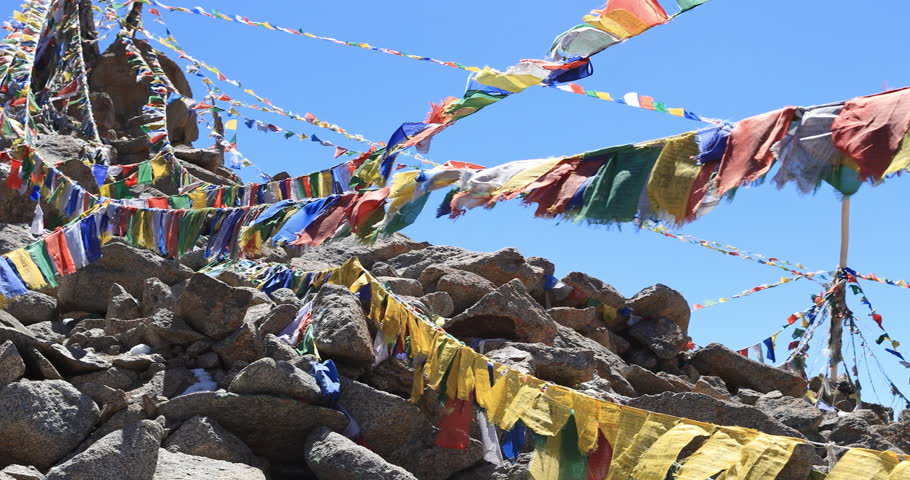 Himalaya mountains background with Buddhist prayer flags slow motion video. North India travel landscape | Shutterstock HD Video #1028872634