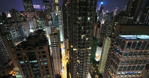 Office building windows and high city towers in Hong Kong town centre at night