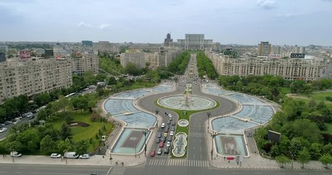 Footage of Unirii Boulevard Fountains in Bucharest with House of the People in the background.