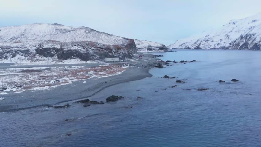 Aerial view of snowy mountains and bay in Dutch Harbor Alaska during winter