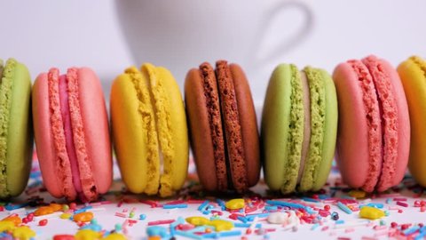 Sweet macaroons with multi colored confectionery dressing. Slide from right to left. Close up. – Video có sẵn