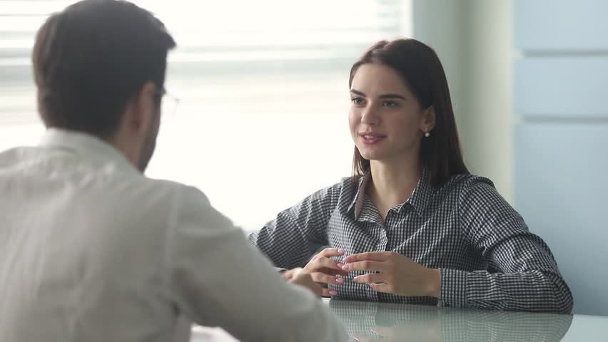 Confident young female applicant talking to hr manager recruiter shake hand of vacancy candidate thanking for job interview or hiring seeker at business meeting, employment handshake, recruit concept Royalty-Free Stock Footage #1028900012